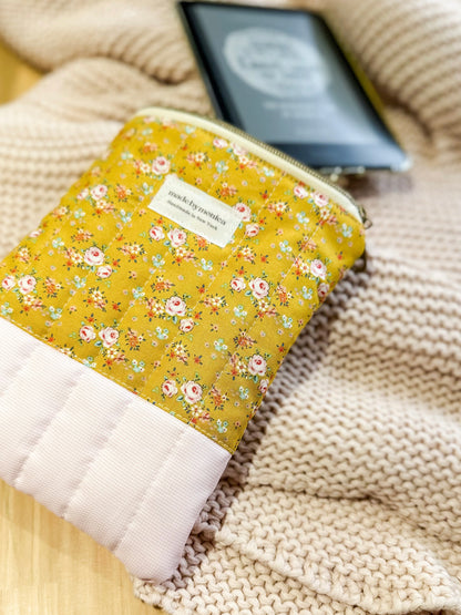 Floral-patterned pouch on a textured surface